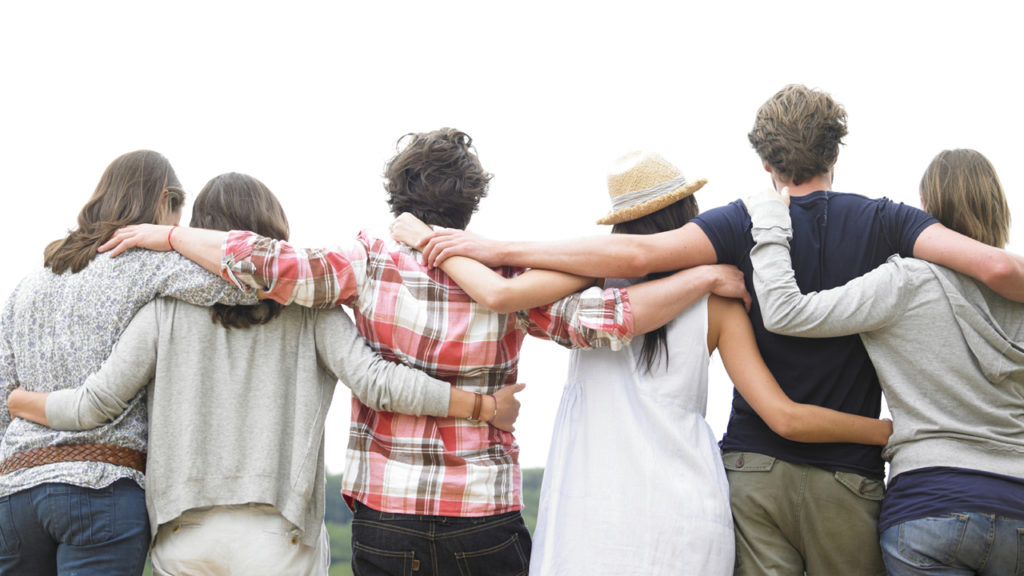 backs of people with arms around each other