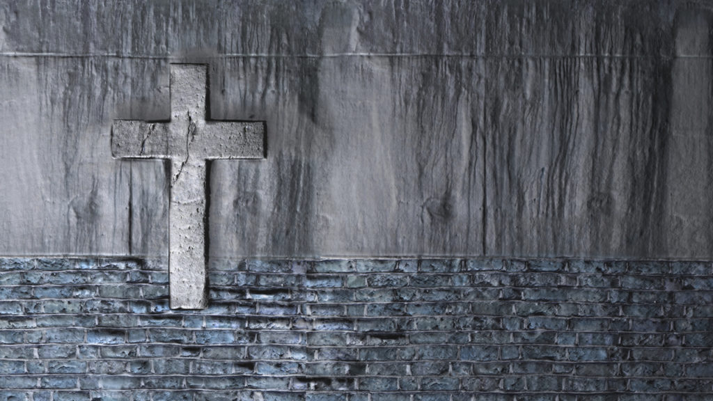 cross against a gray wall