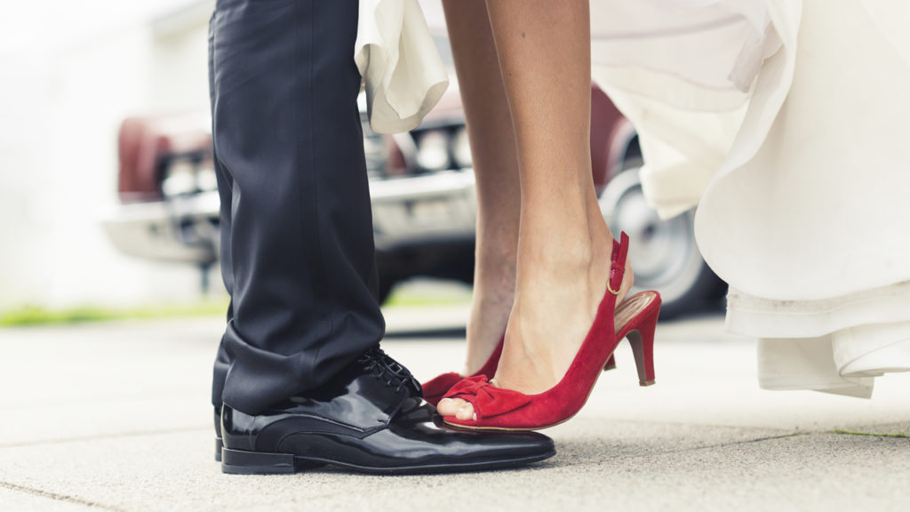 bride standing on groom's feet