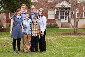 Candice Waters standing with her husband, Steve, and their four children.