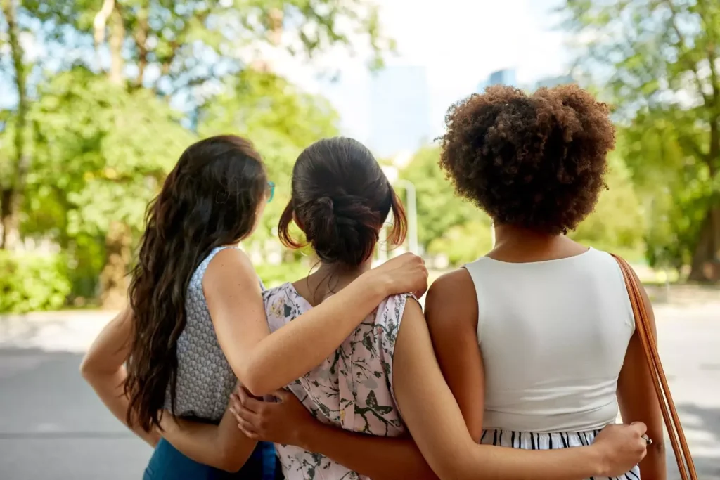 3 female friends hugging, learning to forgive