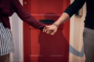 a couple holding hands, bringing them home for the holidays