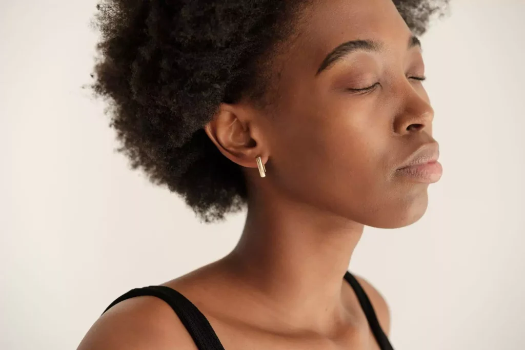 a woman with her eyes closed, not believing the lies she's hearing about herself