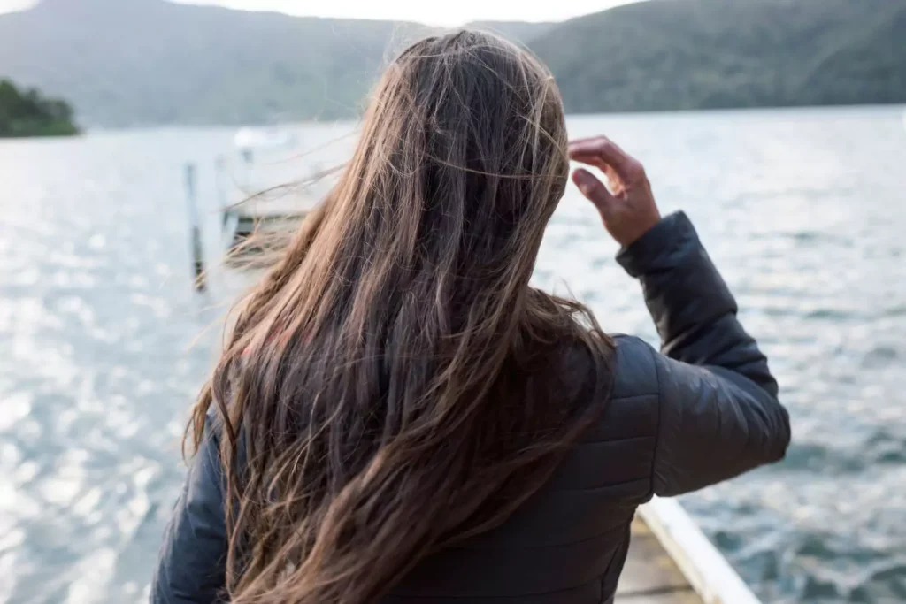 a woman standing on a dock, considering counseling