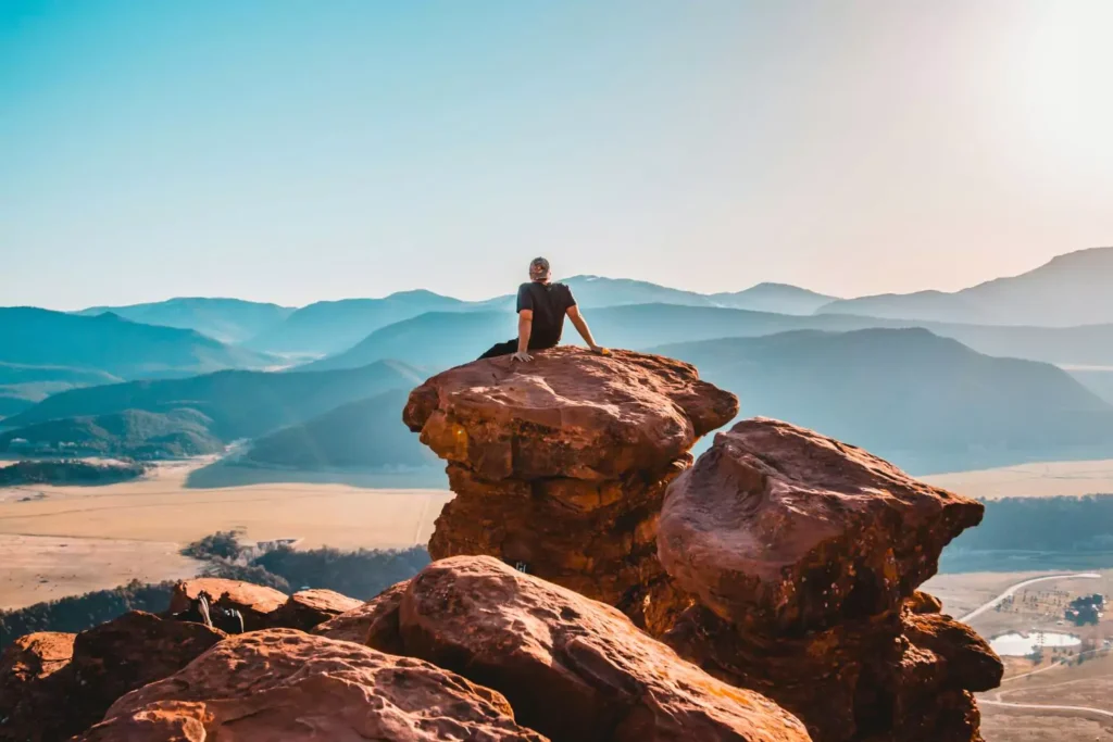 a man sitting on a large rock contemplating a season of celibacy