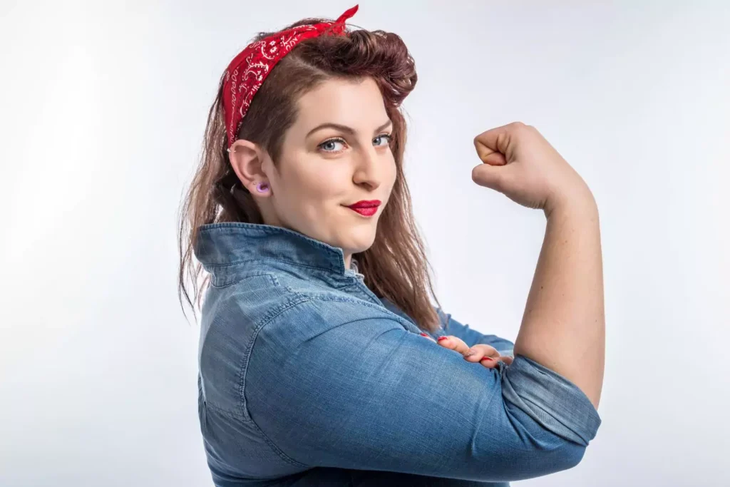 a strong woman posing like Rosie the Riveter