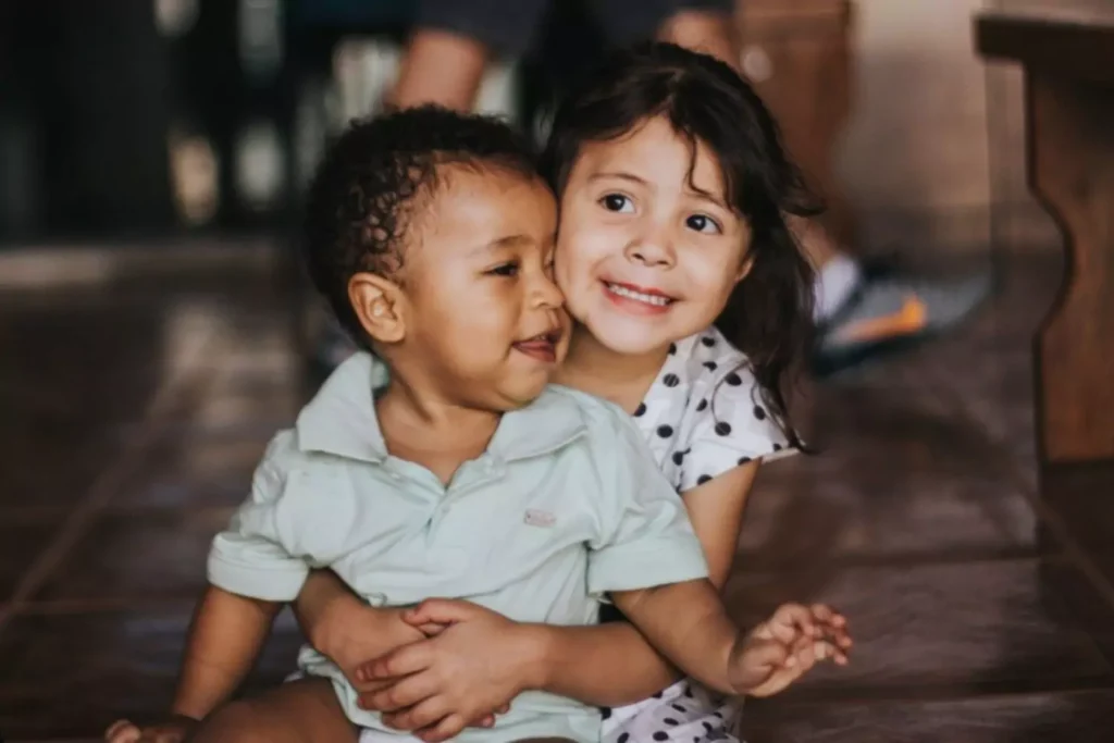 two small orphan children hugging one another