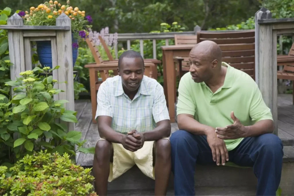 a young man talking to his parent
