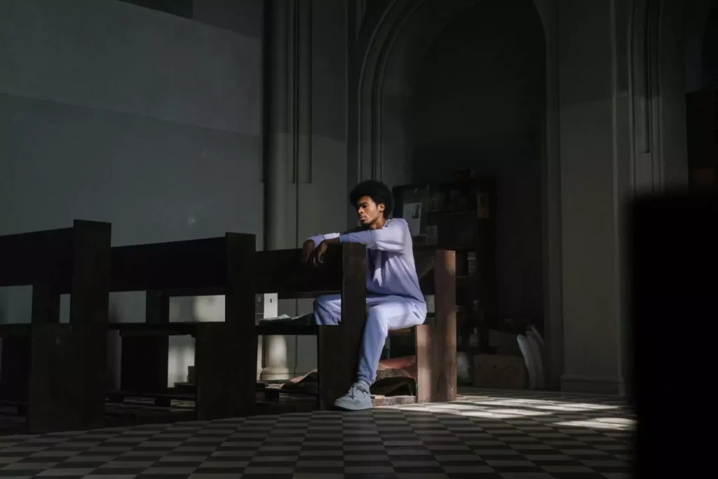 a man sitting alone in a church pew