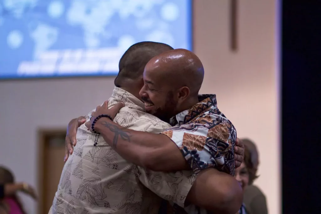two men hugging in their local church