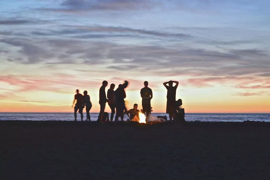 people gathered around a campfire, created for community