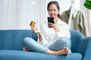 a woman online shopping on her phone, having let the lifestyle creep settle in