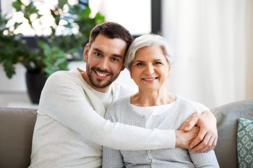 a man hugging his mom, he moved back in with his parents