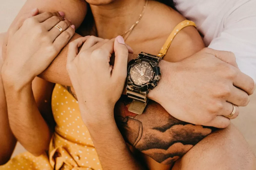 a man hugging his wife from behind - navigating differences in their relationship