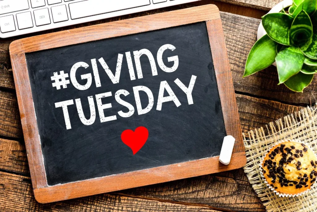 a chalkboard sign that says #givingtuesday