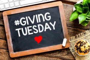 a chalkboard sign that says #givingtuesday