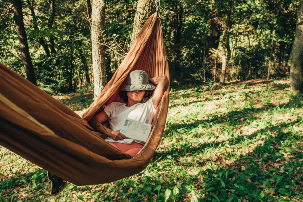 a woman napping in a hammock, taking a restful vacation