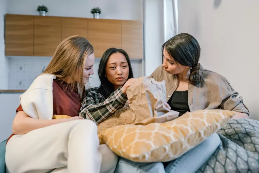 three women talking to each other, being vulnerable