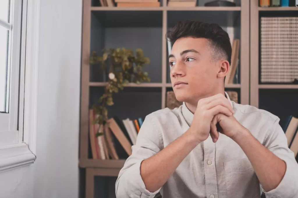 a man looking out a window, searching for beauty