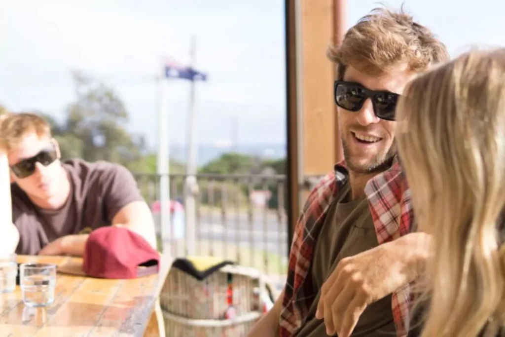 a guy hanging with his friends who are a couple, he's the odd man out