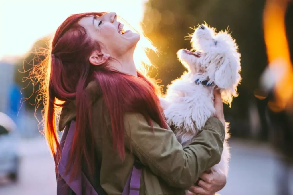 a single woman smiling with her dog