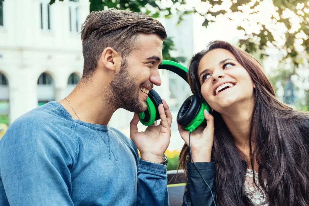 a guy and his girl buddy listening to music