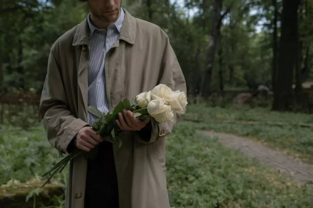 a man holding a bouquet of flowers. One-sided love