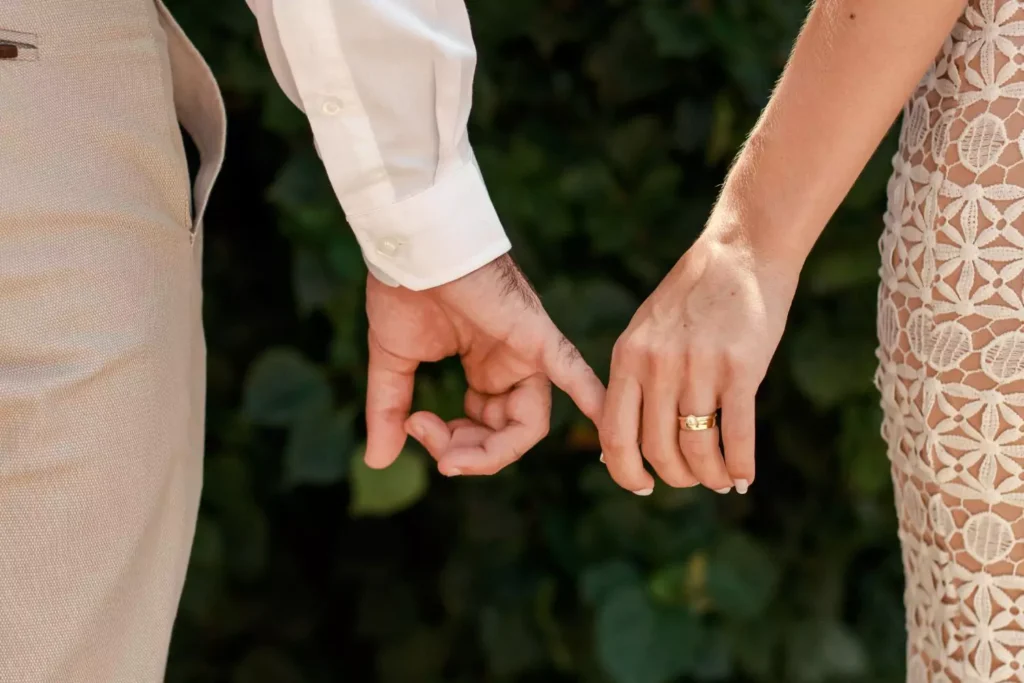 a man and wife holding hands, having waited until marriage to have sex