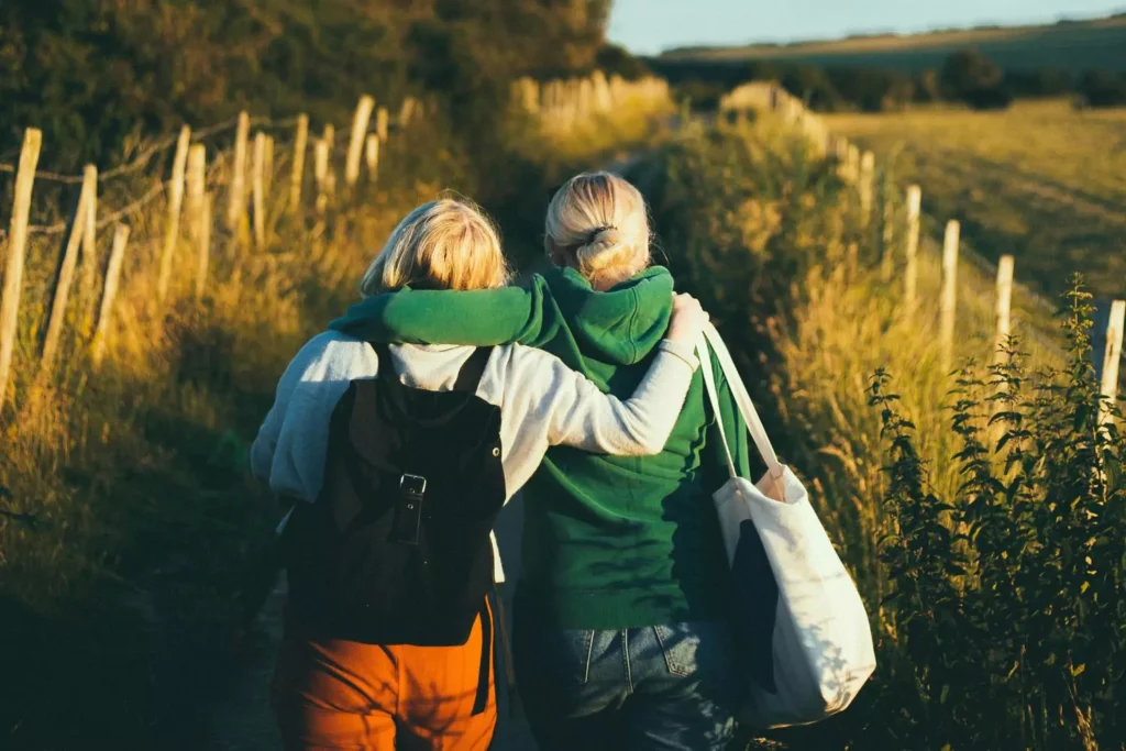 a mentor and her mentee walking on a path