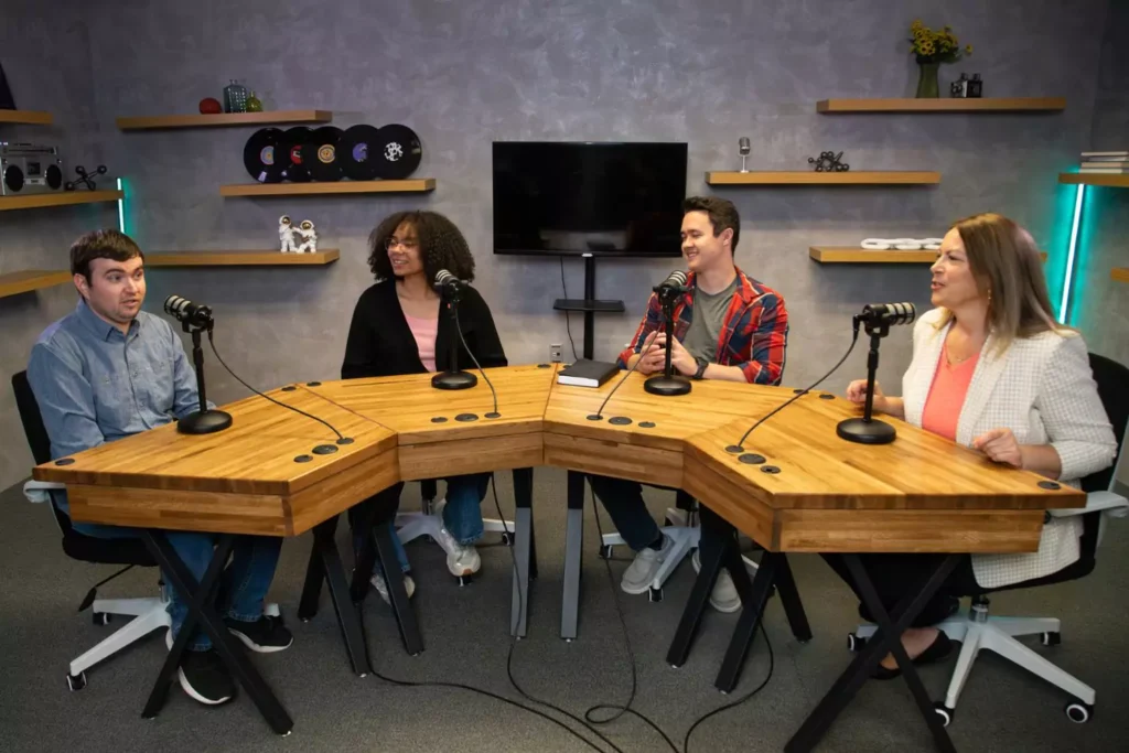 a group of young adults and Lisa Anderson recording a roundtable segment
