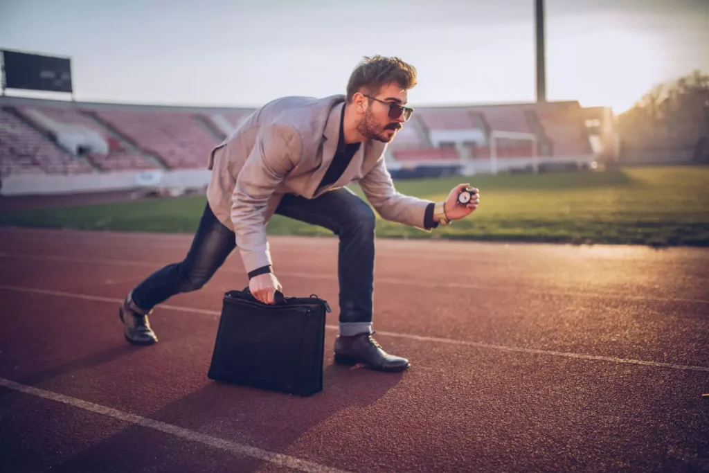 a business man, posed ready for a race