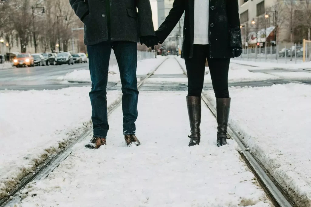two people standing on snowy train tracks, thinking about how the world is sex crazy