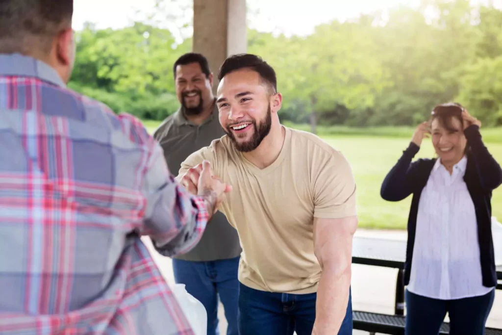 a man shaking another man's hand, inviting him to church