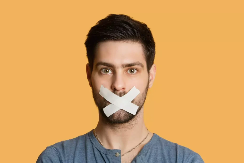 a man with tape over his mouth, providing silence