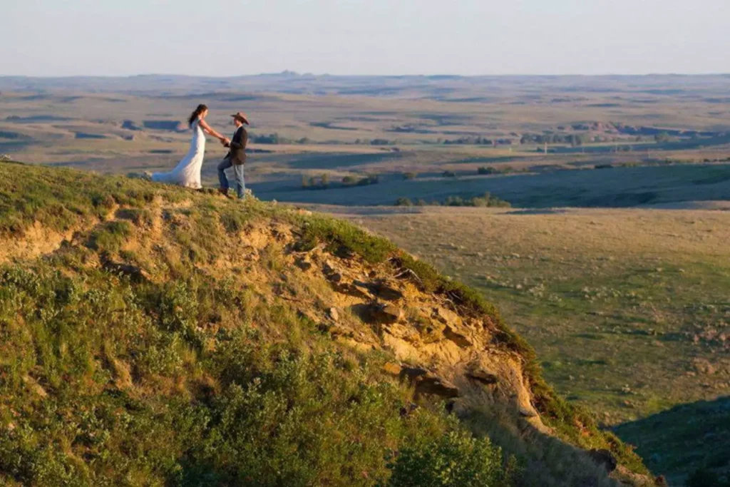 wedding on a hillside, groom wearing a cowboy hat