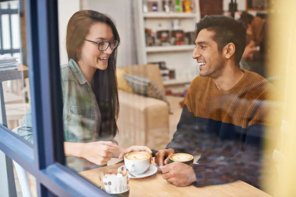 a man and a woman on a first date at a coffee shop