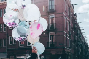 a man carrying balloons to celebrate a new marriage