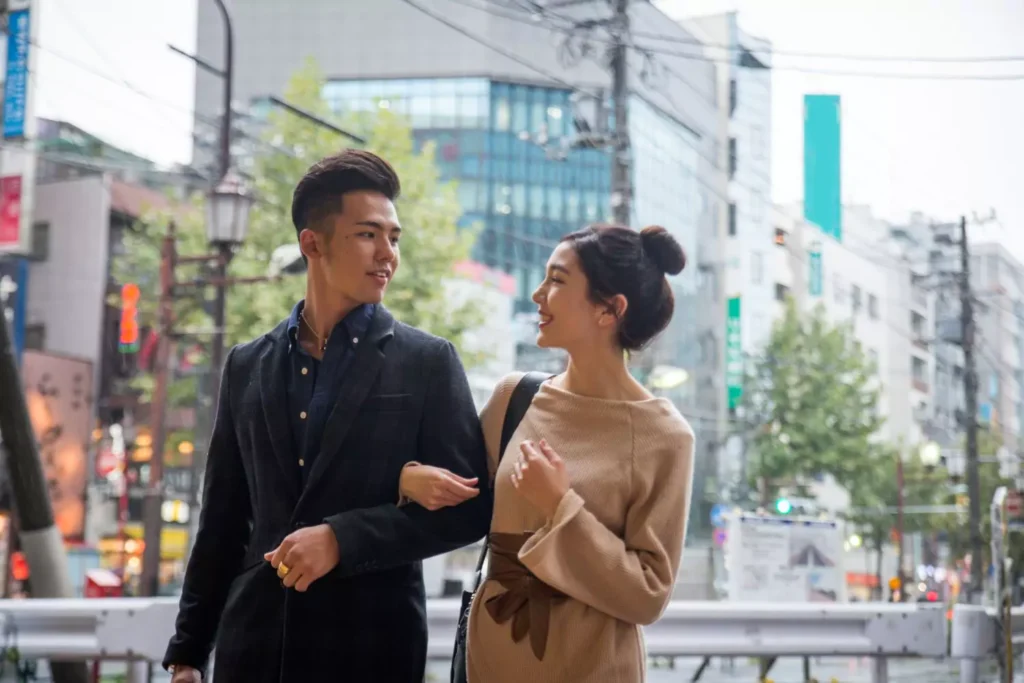a man and woman in a dating relationship walking in a city
