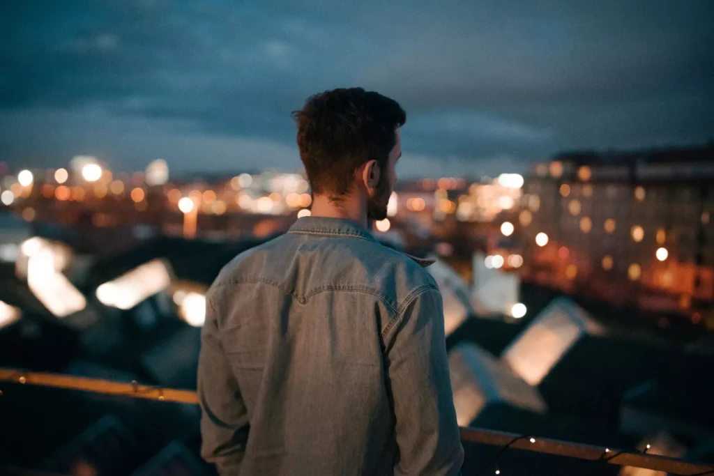 a man looking out over a city, thinking about dating