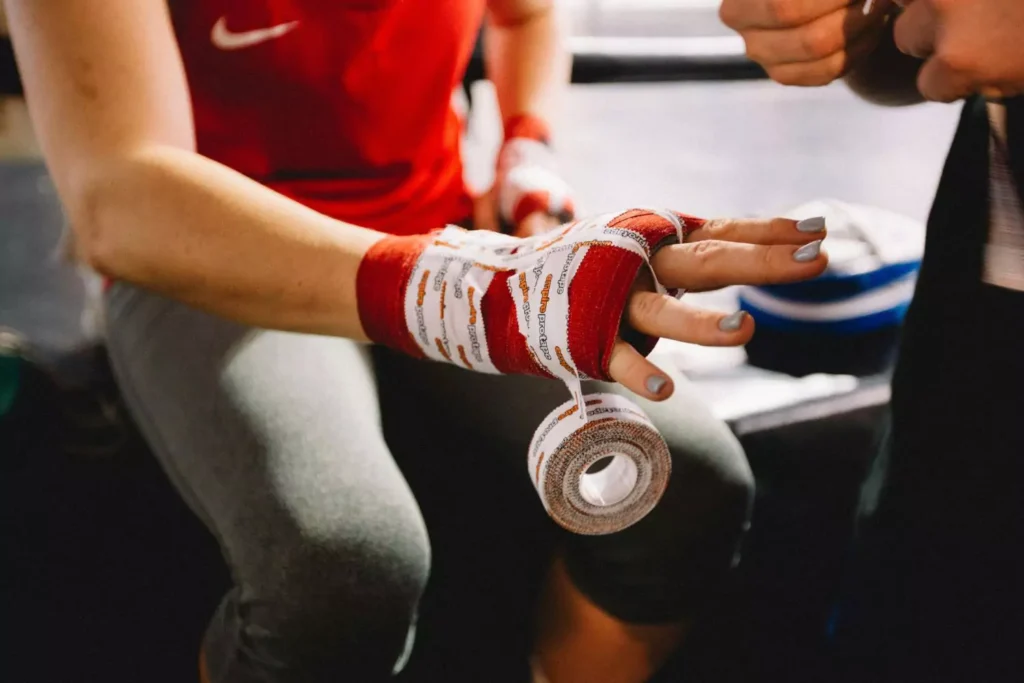 a fighter getting her hand taped for a fight, using her gifts