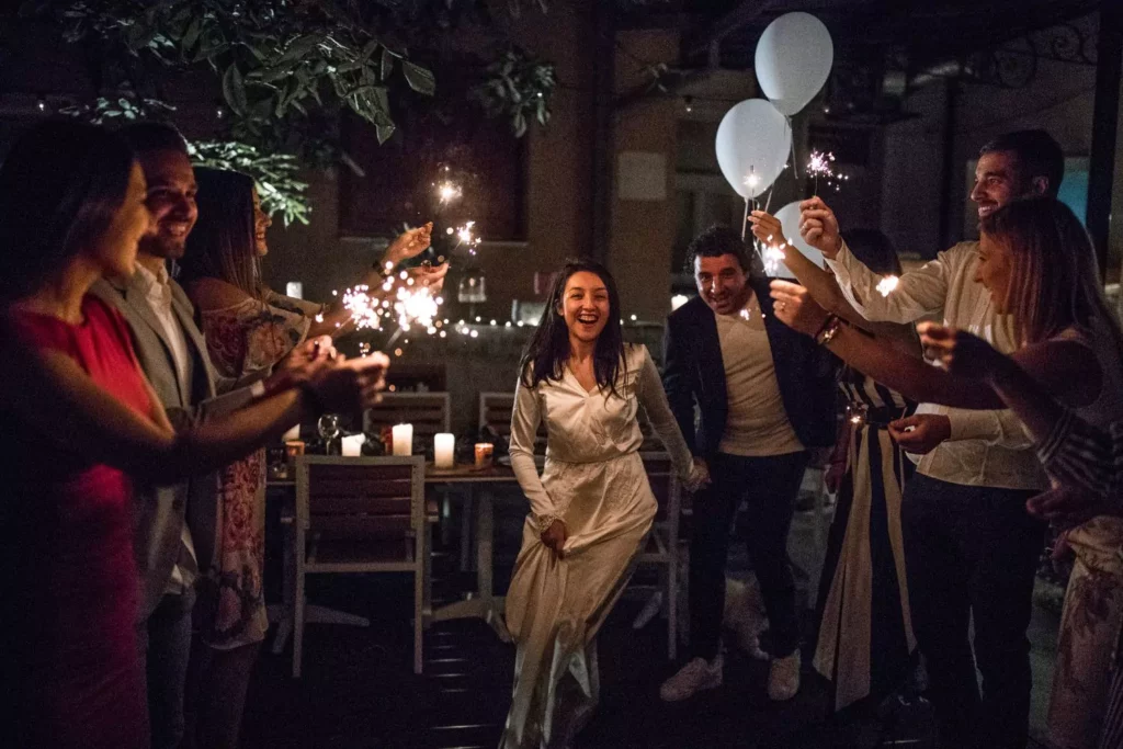 bride and groom exiting their wedding through a tunnel of their friends holding sparklers, they got great marriage advice from their friends and family
