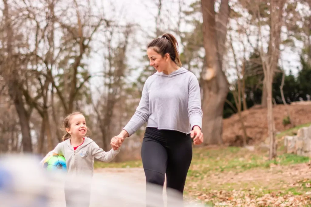 an aunt holding hands with her niece